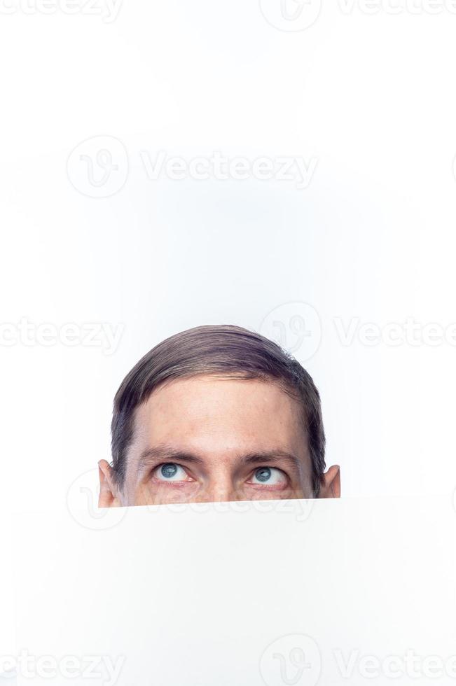 The person's face is covered with a white piece of paper, on an isolated background photo