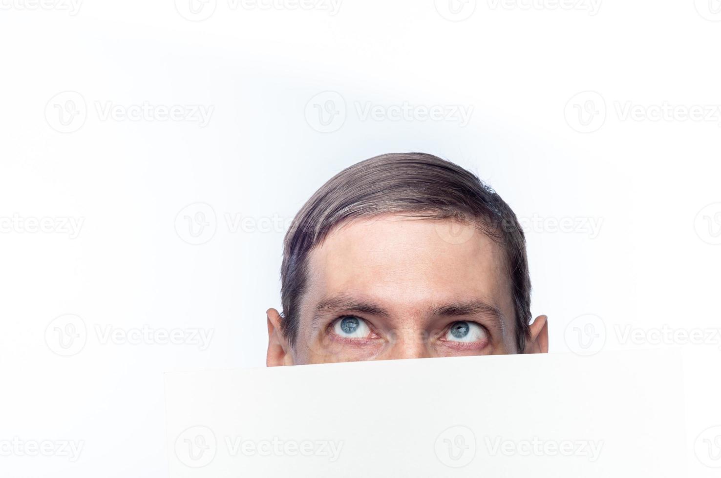 The person's face is covered with a white piece of paper, on an isolated background photo