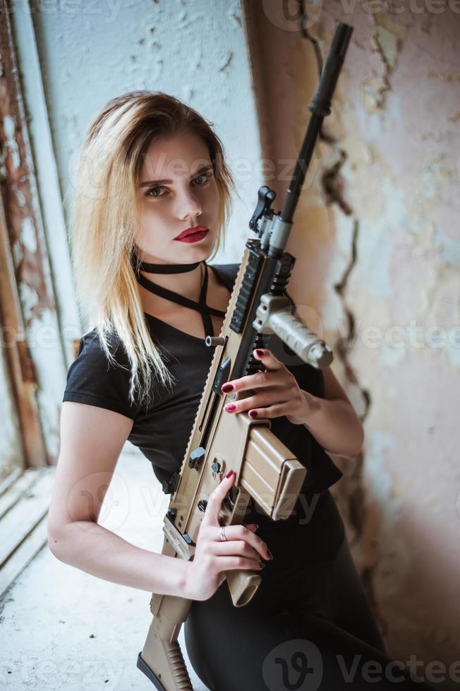 Beautiful portrait of a girl holding a gun photo