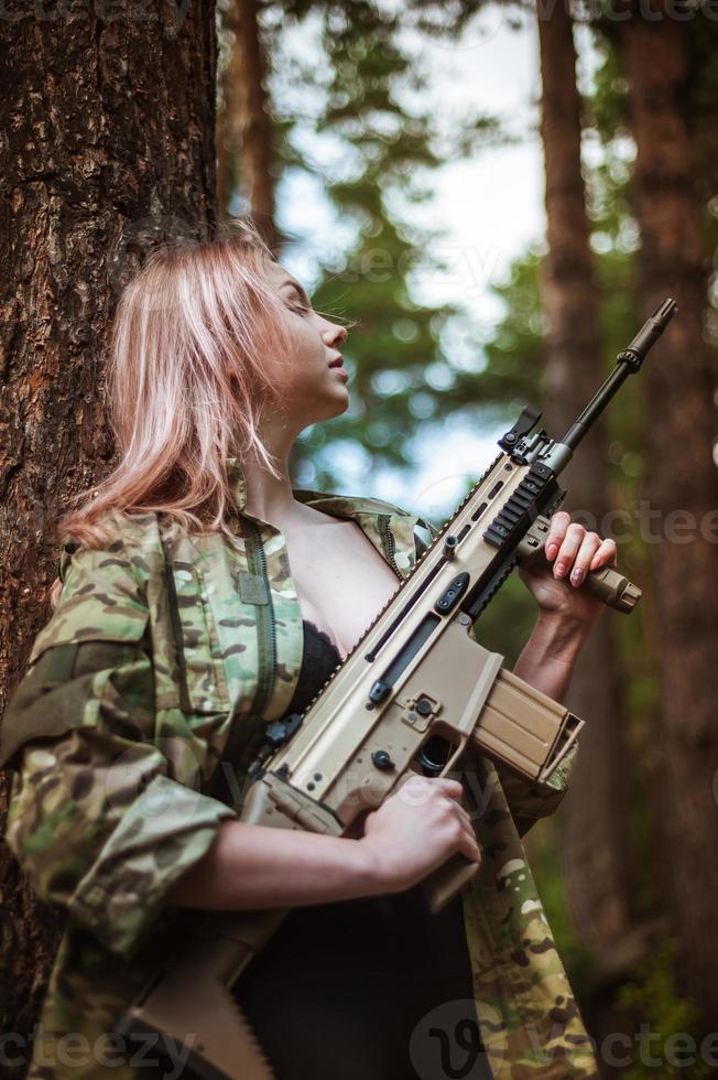 Beautiful portrait of a girl holding a gun photo