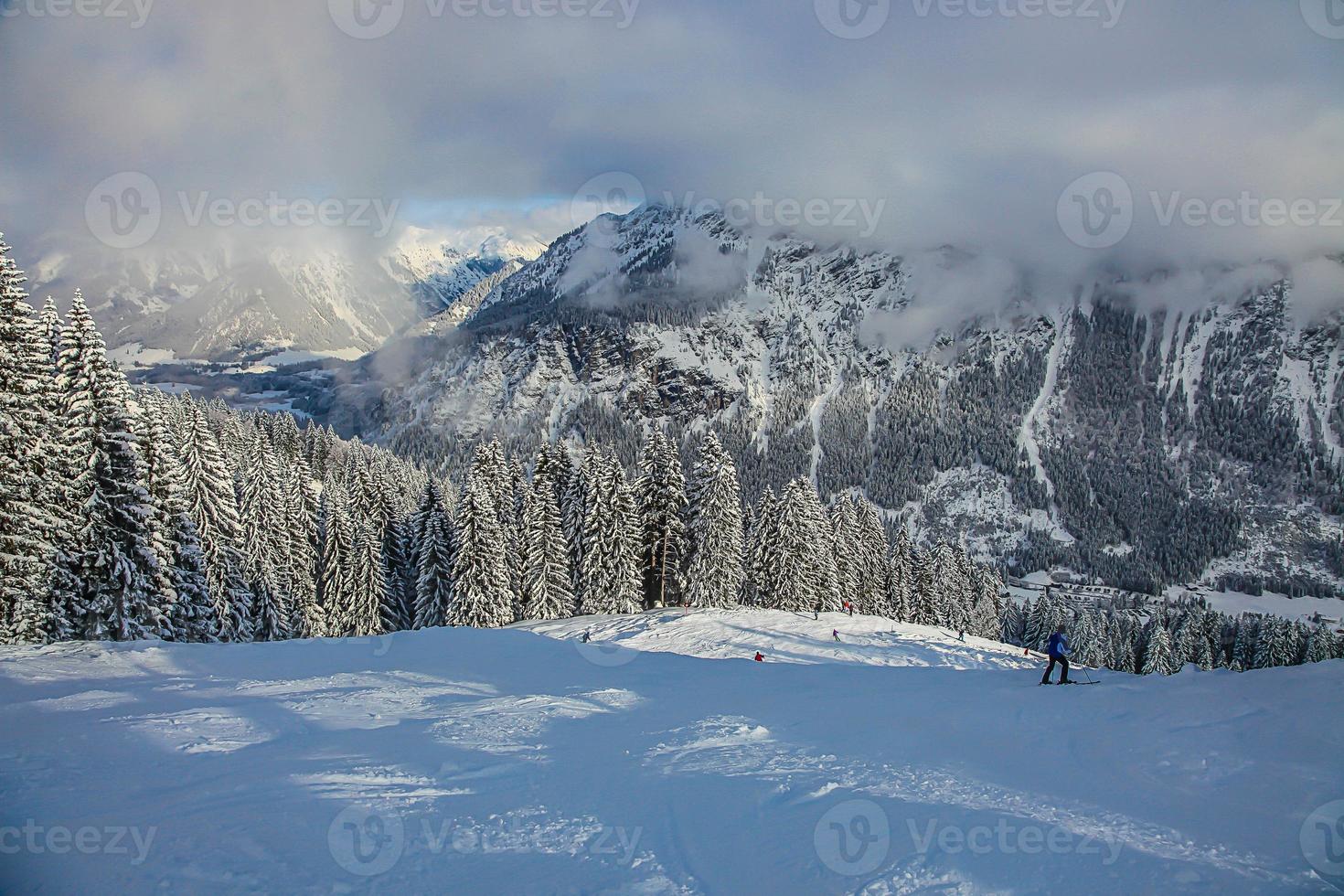 Picture of cloud covered mountains in Austria at wintertime photo