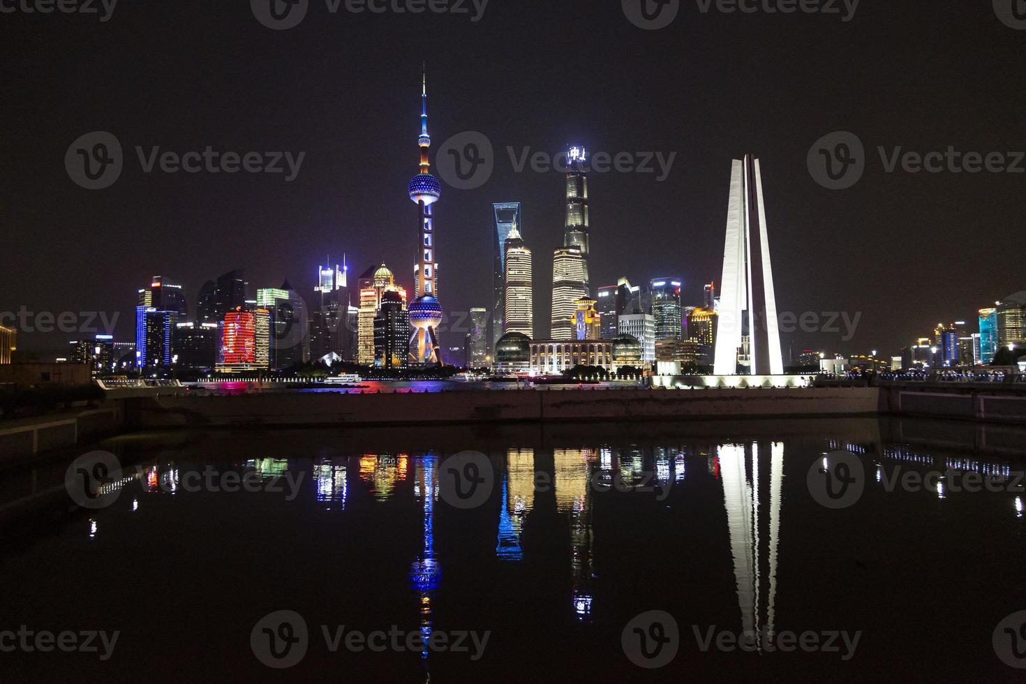 Panoramic picture of skyscrapers of Pudong district from the Bund in Shanghai at night in winter photo