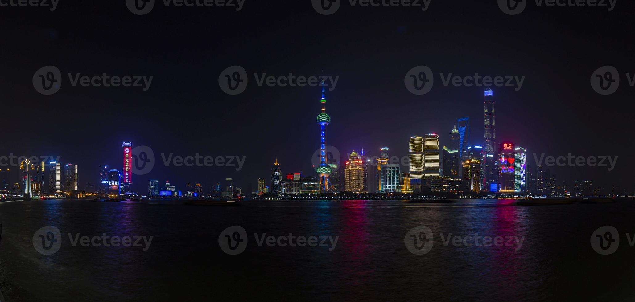 Panoramic picture of skyscrapers of Pudong district from the Bund in Shanghai at night in winter photo