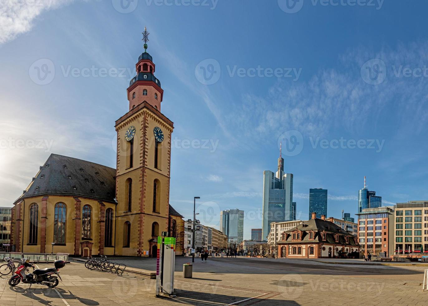 View over the square at the Hauptwache in Frankfurt with St. Catherine's Church and skyscrapers of the skyline in morning light photo