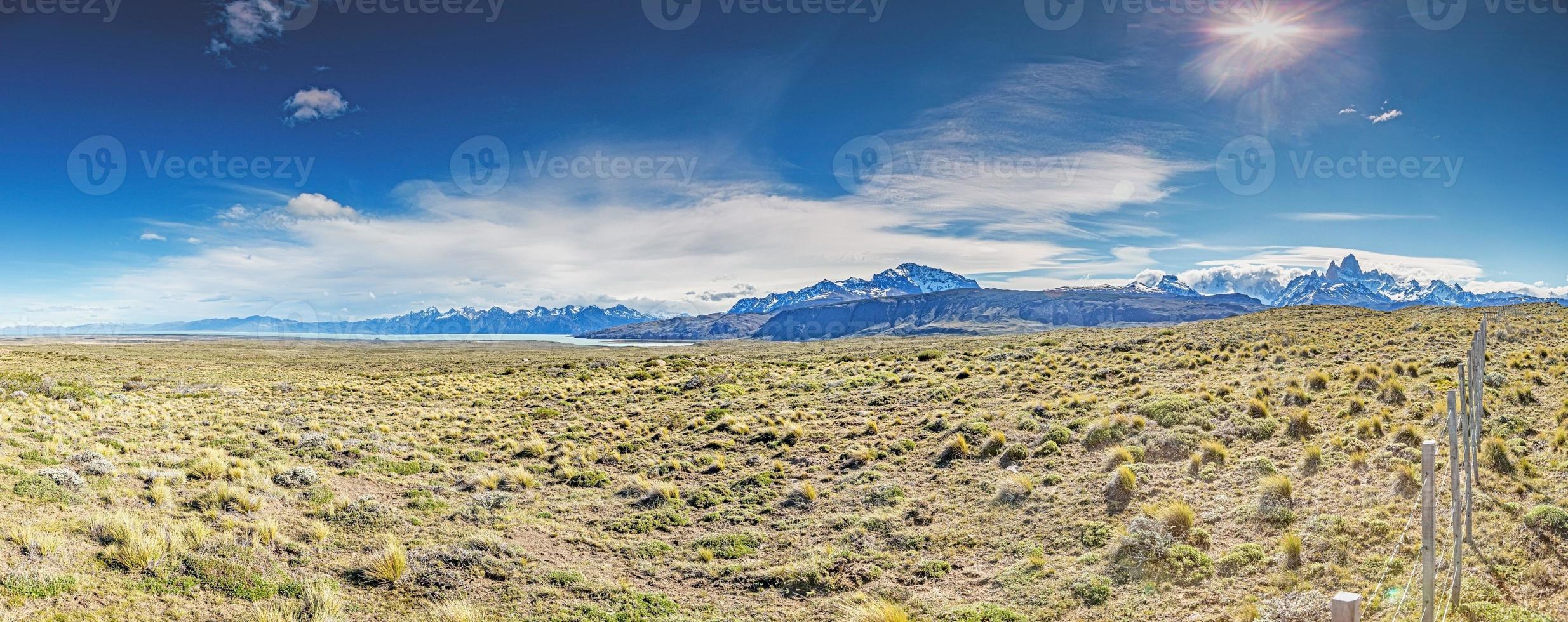 Panoramic image over the Argentine steppe with view of Patagonia mountain range with Cerro Torre and Mount Fitz Roy photo