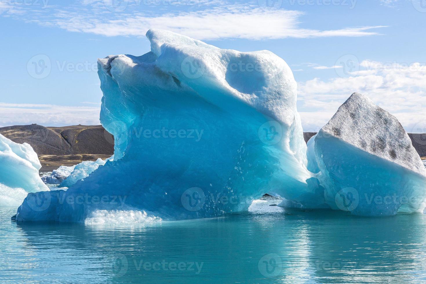 Panoramic pictures over Joekularson glacier lagoon with frifting iceberg in summer during daytime photo