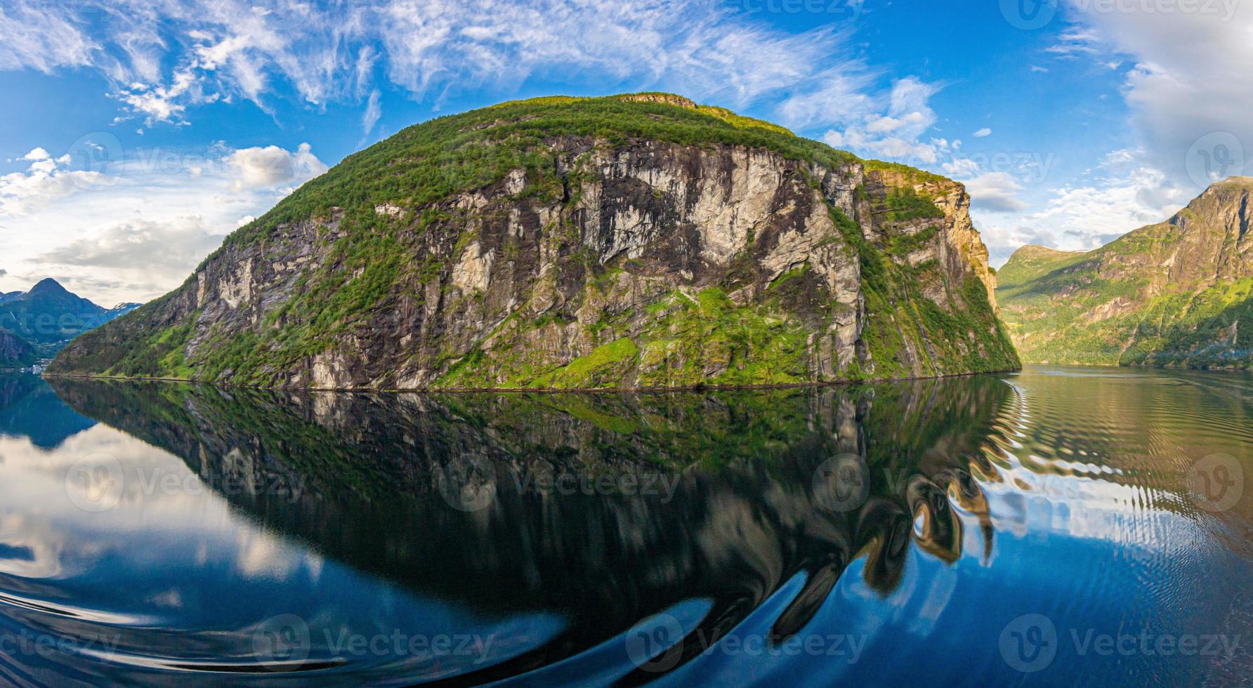 Impression from cruise ship on the way through Geiranger fjord in Norway at sunrise in summer photo