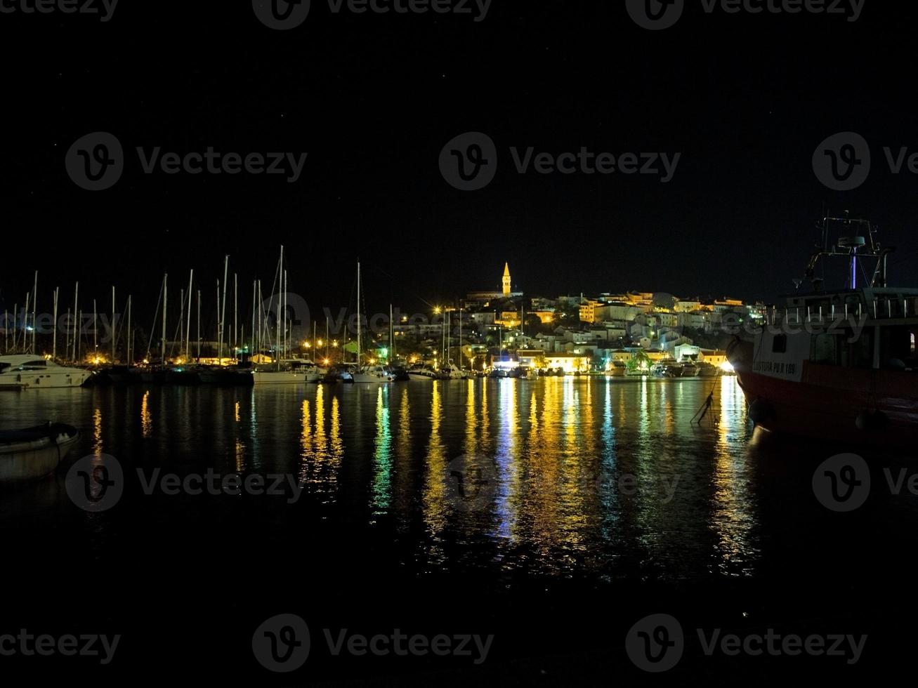 Night panorama over the harbor of the Croatian coastal town of Vrsar in Istria photo