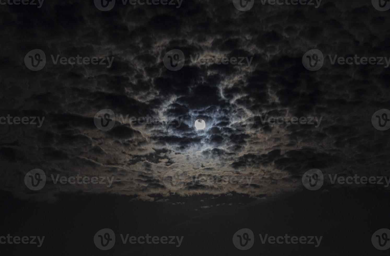 Close up picture of the shiny full moon with cirrostratus clouds photo