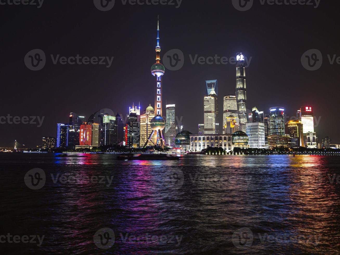 Panoramic picture of skyscrapers of Pudong district from the Bund in Shanghai at night in winter photo