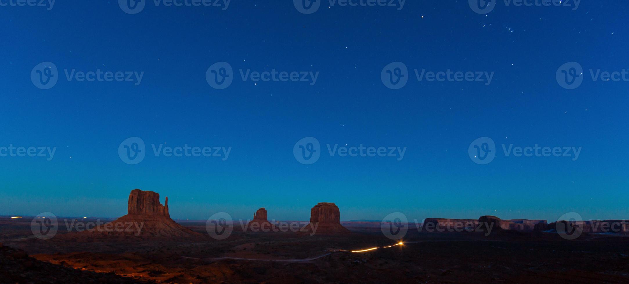 Night scene of rock formation in the Monument Valley National Park with stars in the sky in winter photo