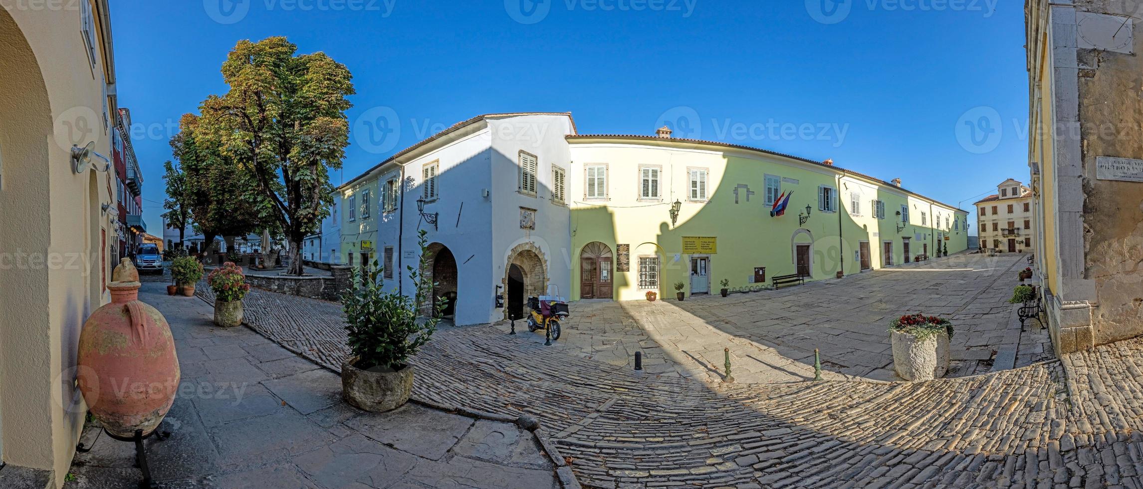 Panorama over the central square of Motovun with St. Stephen's church and city gate at sunrise photo