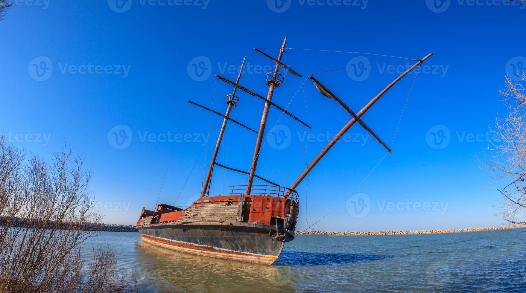 Stranded sailing ship at shore of lake Erie photo