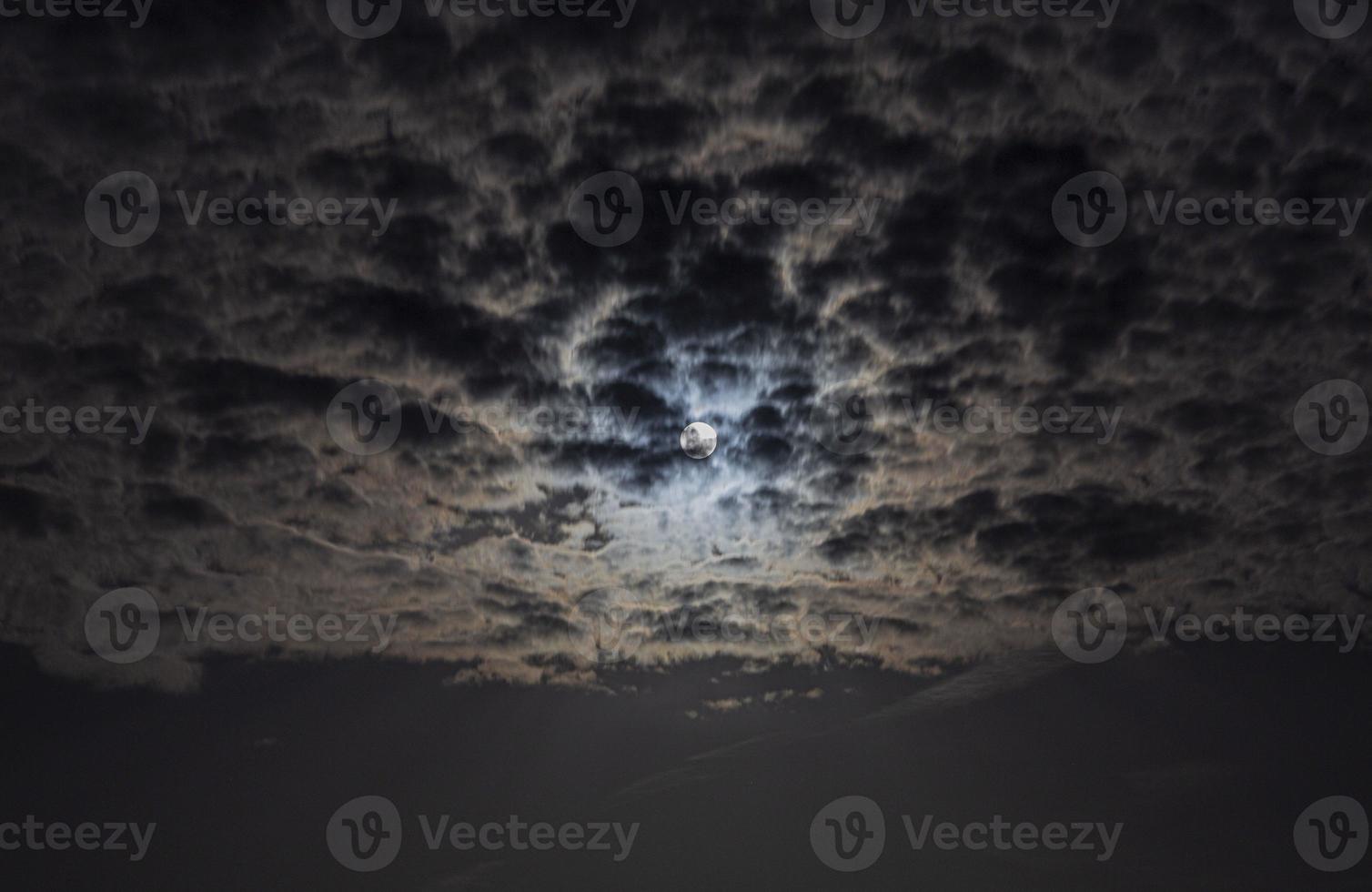 Close up picture of the shiny full moon with cirrostratus clouds photo