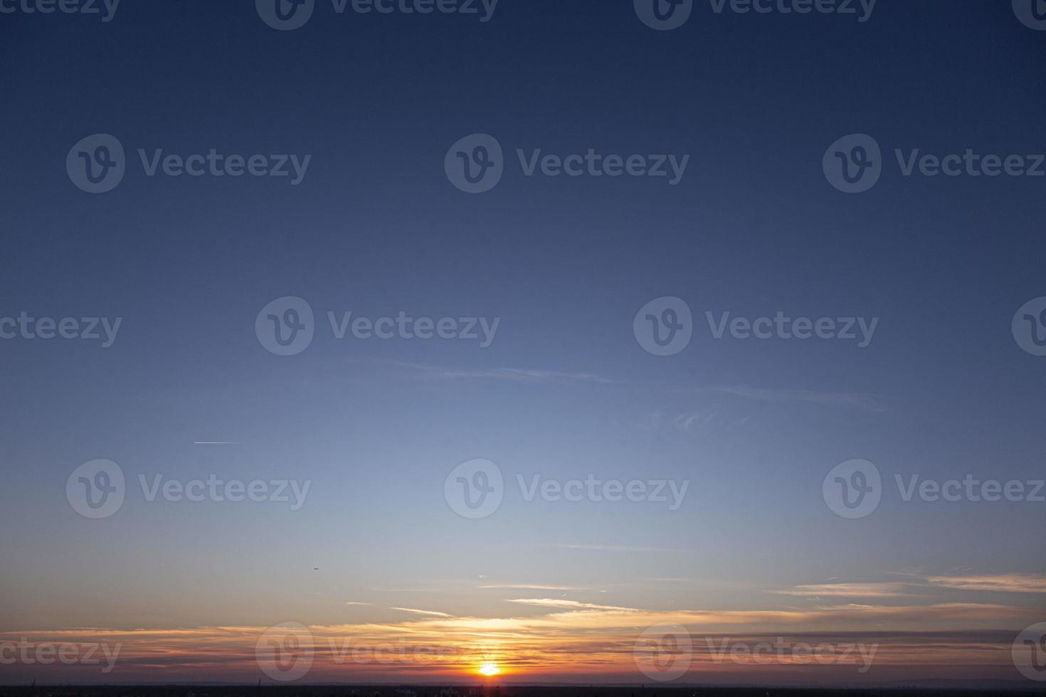 Picture of dramatic and colorful sky with sun during sunset photo