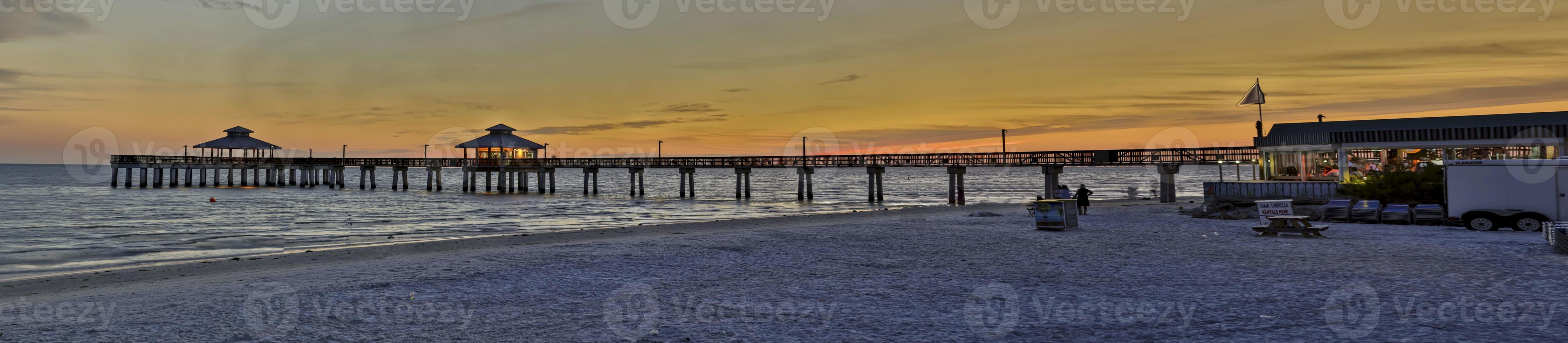 Panoramic picture of Fort Myers fishing pier at sunrise with afterglow photo