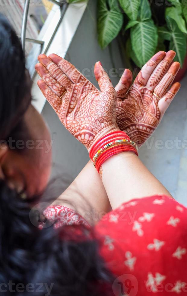 Beautiful woman dressed up as Indian tradition with henna mehndi design on her both hands to celebrate big festival of Karwa Chauth, Karwa Chauth celebrations by Indian woman for her husband photo