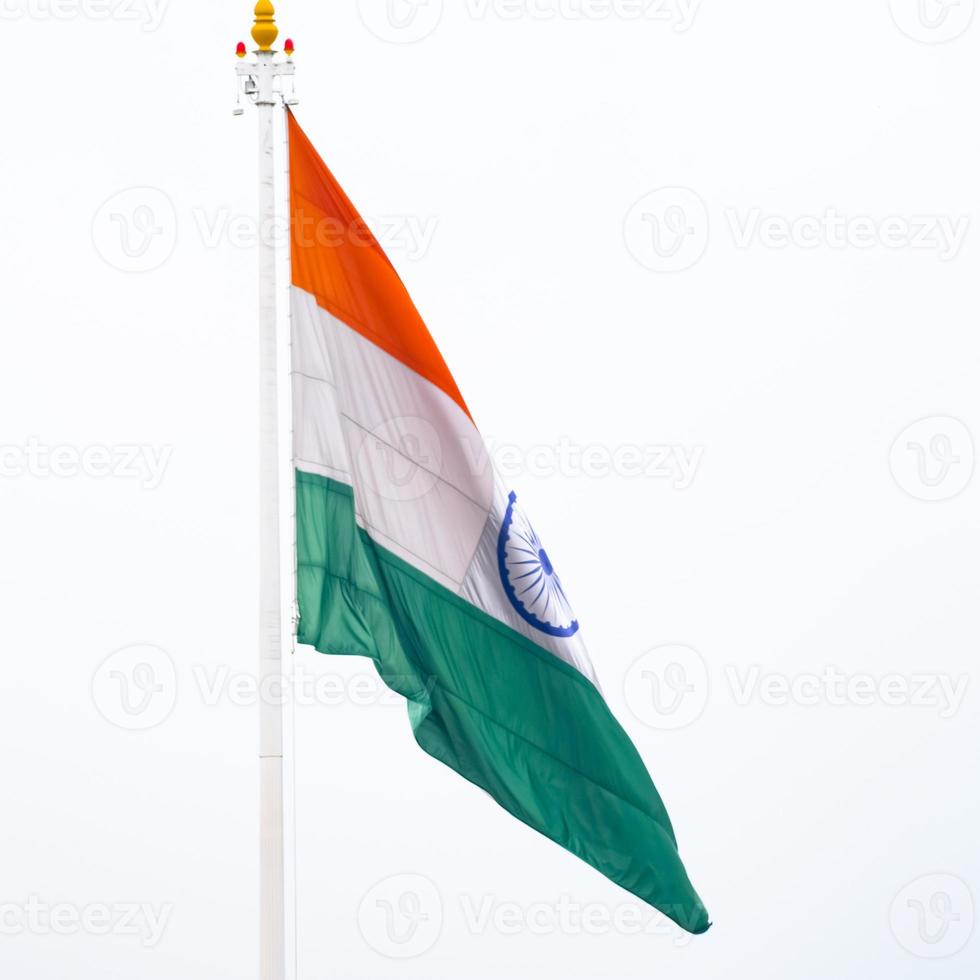 India flag flying high at Connaught Place with pride in blue sky, India flag fluttering, Indian Flag on Independence Day and Republic Day of India, tilt up shot, Waving Indian flag, Har Ghar Tiranga photo