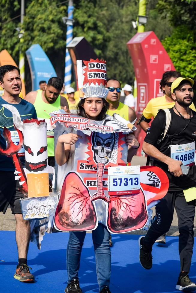 New Delhi, India - October 16 2022 - Vedanta Delhi Half Marathon race after covid in which marathon participants about to cross the finish line, Delhi Half Marathon 2022 photo