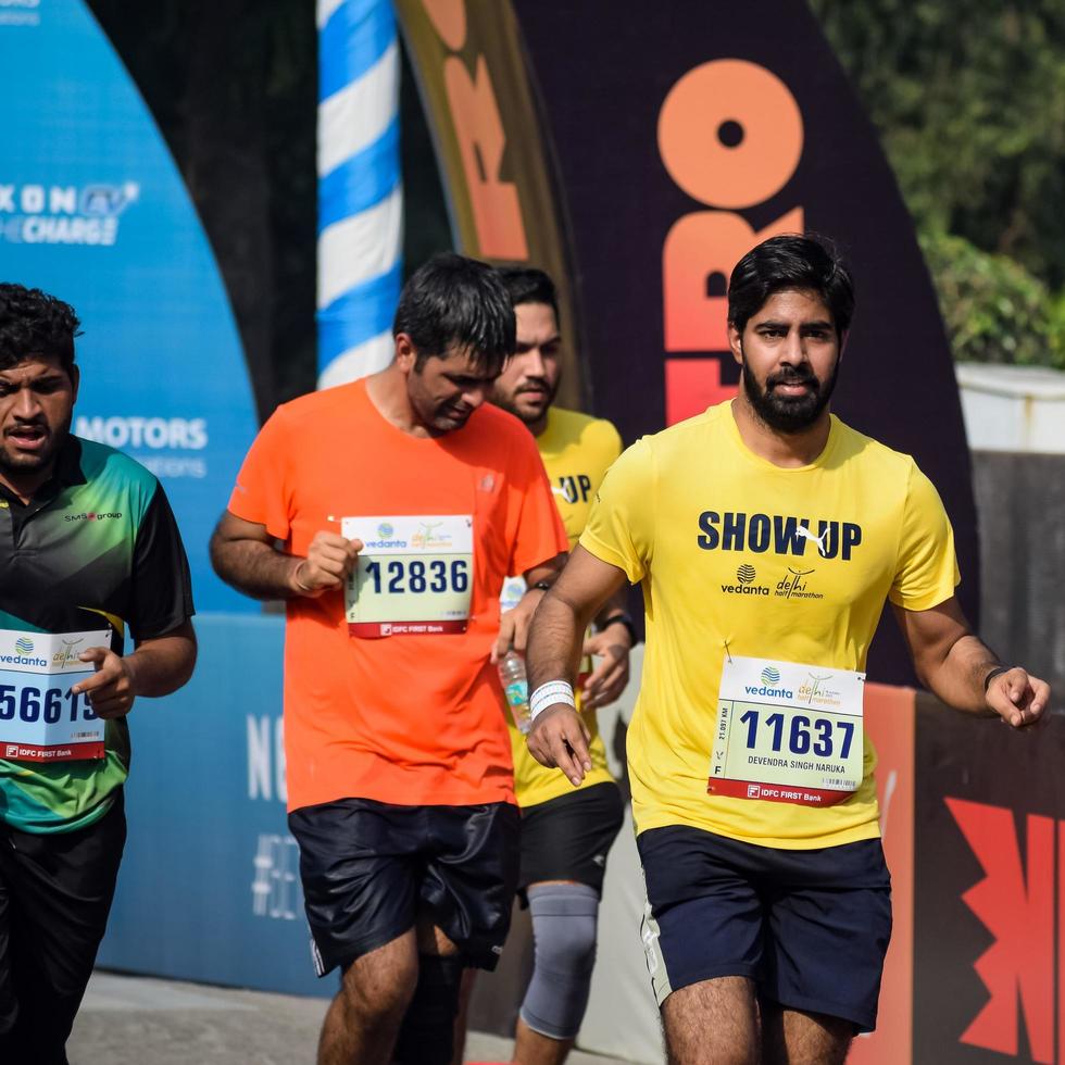 New Delhi, India - October 16 2022 - Vedanta Delhi Half Marathon race after covid in which marathon participants about to cross the finish line, Delhi Half Marathon 2022 photo