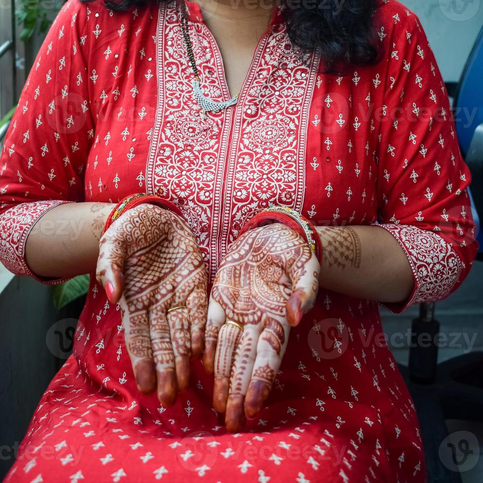 Beautiful woman dressed up as Indian tradition with henna mehndi design on her both hands to celebrate big festival of Karwa Chauth, Karwa Chauth celebrations by Indian woman for her husband photo