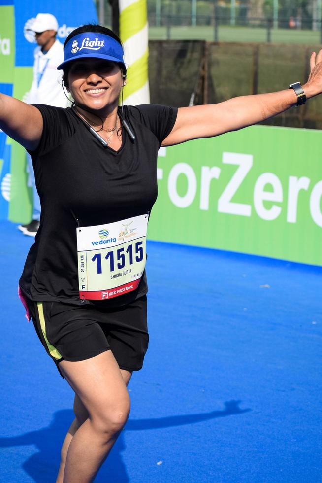 New Delhi, India - October 16 2022 - Vedanta Delhi Half Marathon race after covid in which marathon participants about to cross the finish line, Delhi Half Marathon 2022 photo