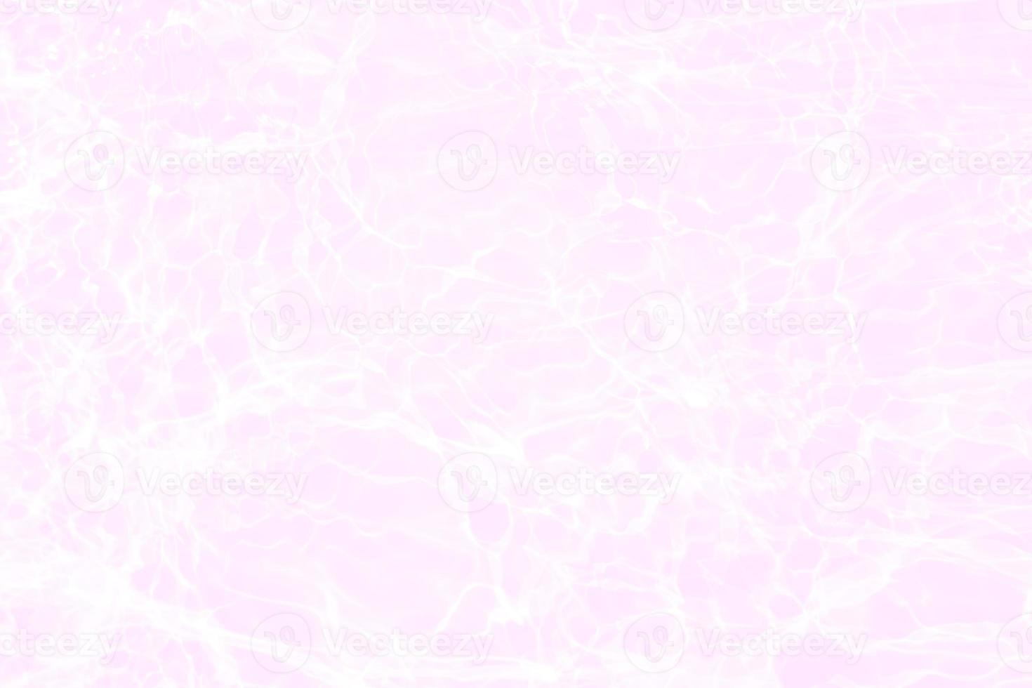 Defocus blurred transparent orange colored clear calm water surface texture with splashes and bubbles. Trendy abstract nature background. Water waves in sunlight with caustics. Pink water shinning photo