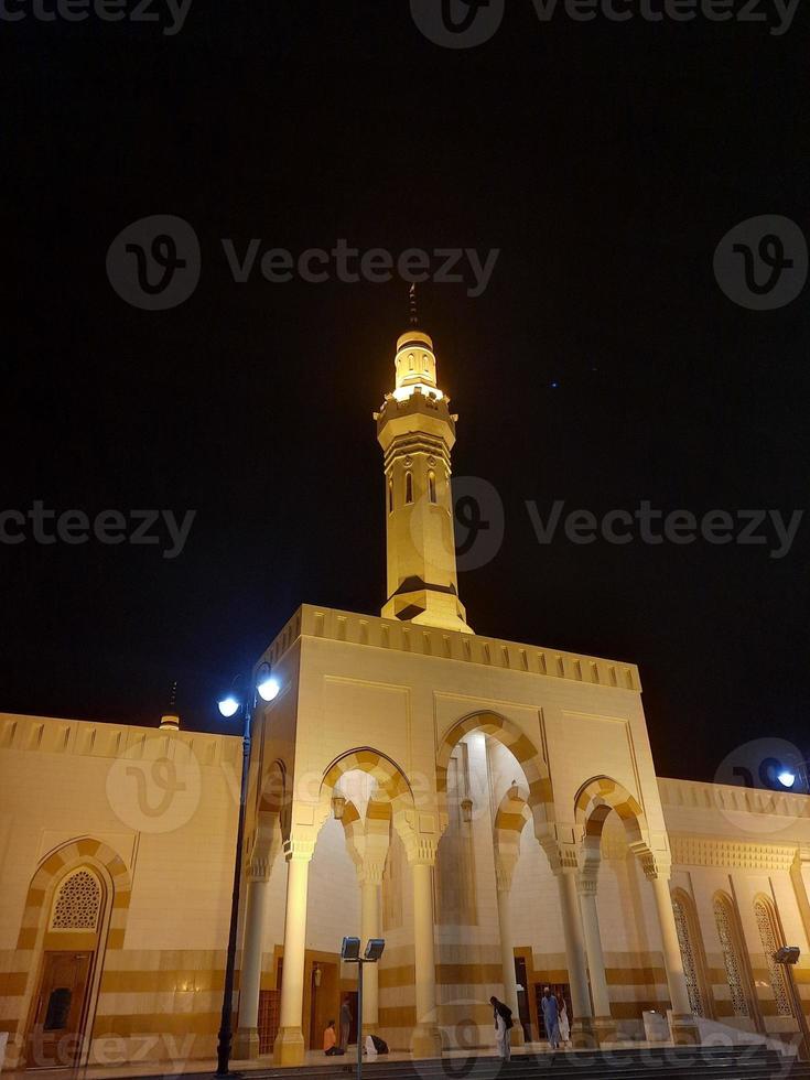 A beautiful night view of the Sayed Al Shuhada Mosque in Madinah, Saudi Arabia photo