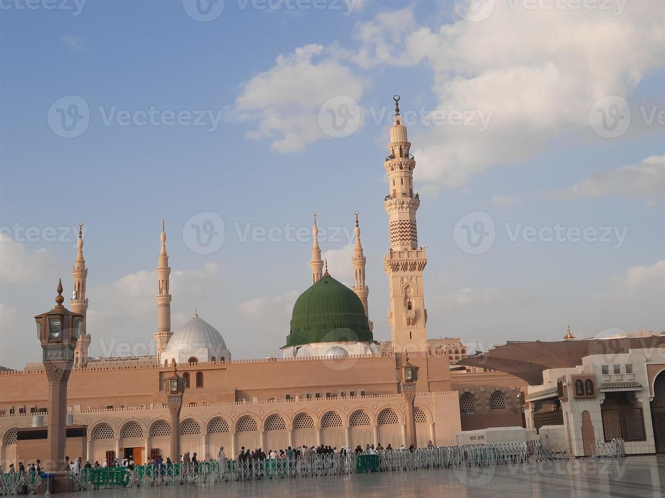 Beautiful daytime view of Masjid Al Nabawi, Medina's green dome, minarets and mosque courtyard. photo