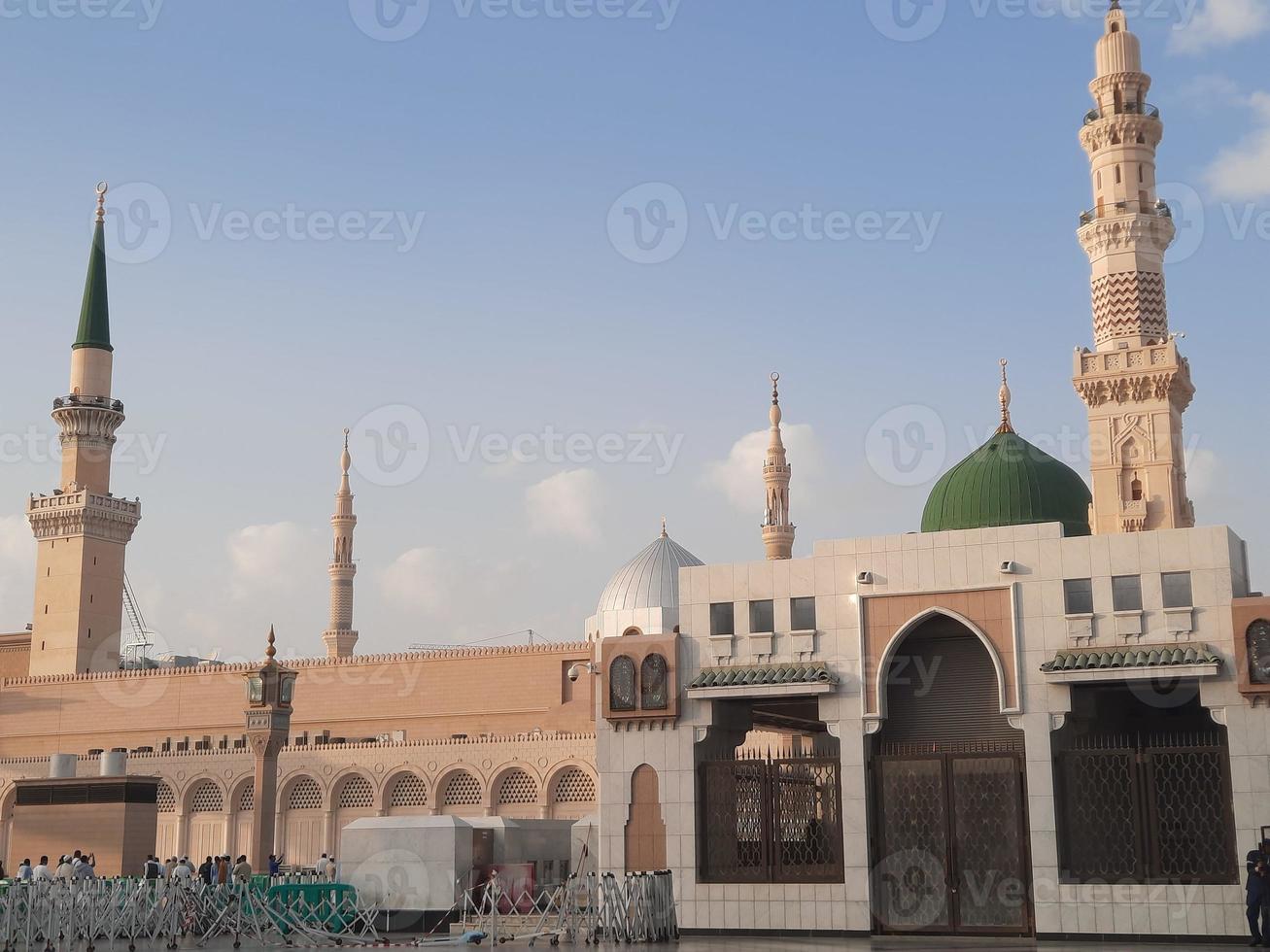 Beautiful daytime view of Masjid Al Nabawi, Medina's green dome, minarets and mosque courtyard. photo