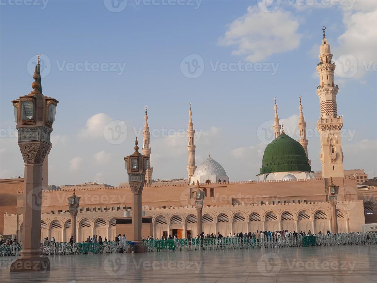 Beautiful daytime view of Masjid Al Nabawi, Medina's green dome, minarets and mosque courtyard. photo