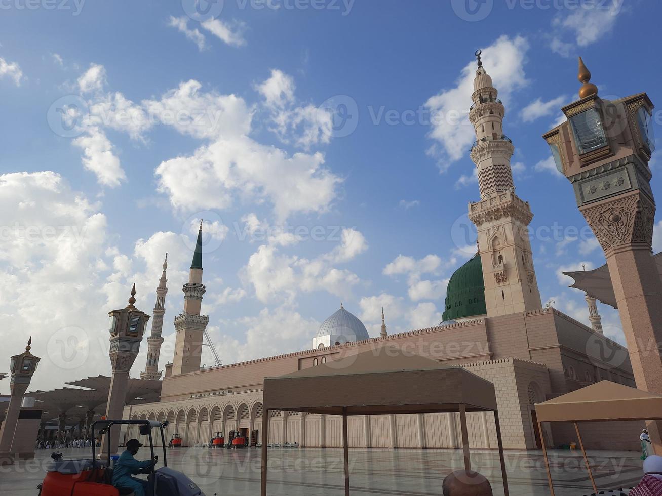 Beautiful daytime view of Masjid Al Nabawi, Medina's green dome, minarets and mosque courtyard. photo