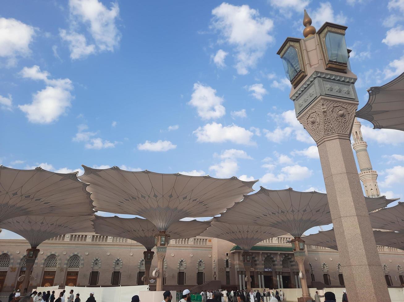 Medina, Saudi Arabia, Dec 2022 - During the day pilgrims from all over the world gather in the outer courtyard of Masjid Al Nabawi, Madinah, Saudi Arabia. photo