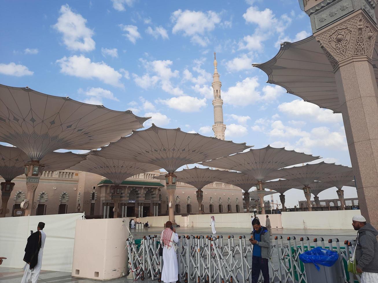 Medina, Saudi Arabia, Dec 2022 - During the day pilgrims from all over the world gather in the outer courtyard of Masjid Al Nabawi, Madinah, Saudi Arabia. photo