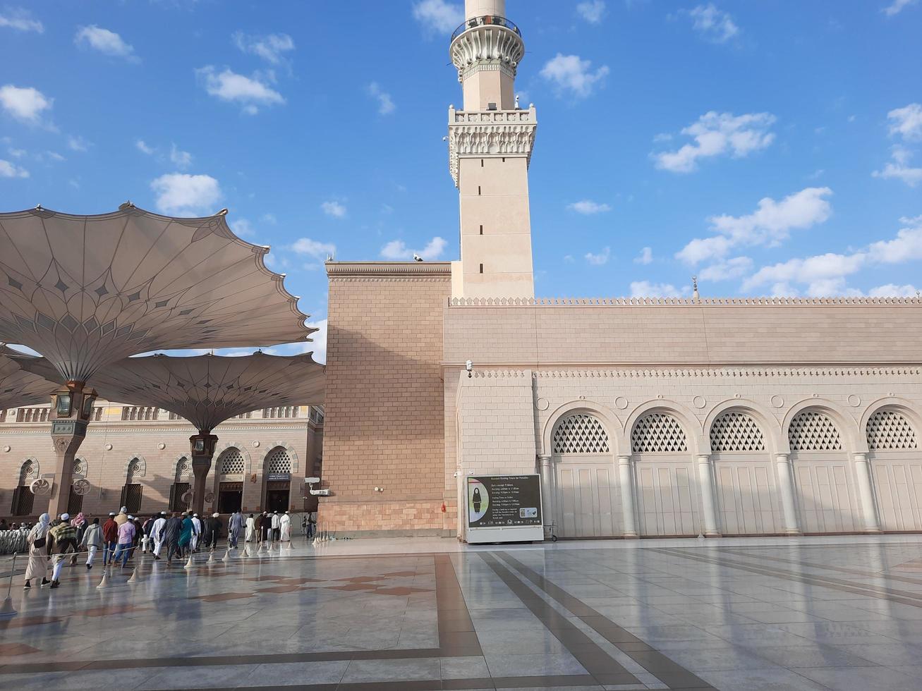 Medina, Saudi Arabia, Dec 2022 - During the day pilgrims from all over the world gather in the outer courtyard of Masjid Al Nabawi, Madinah, Saudi Arabia. photo