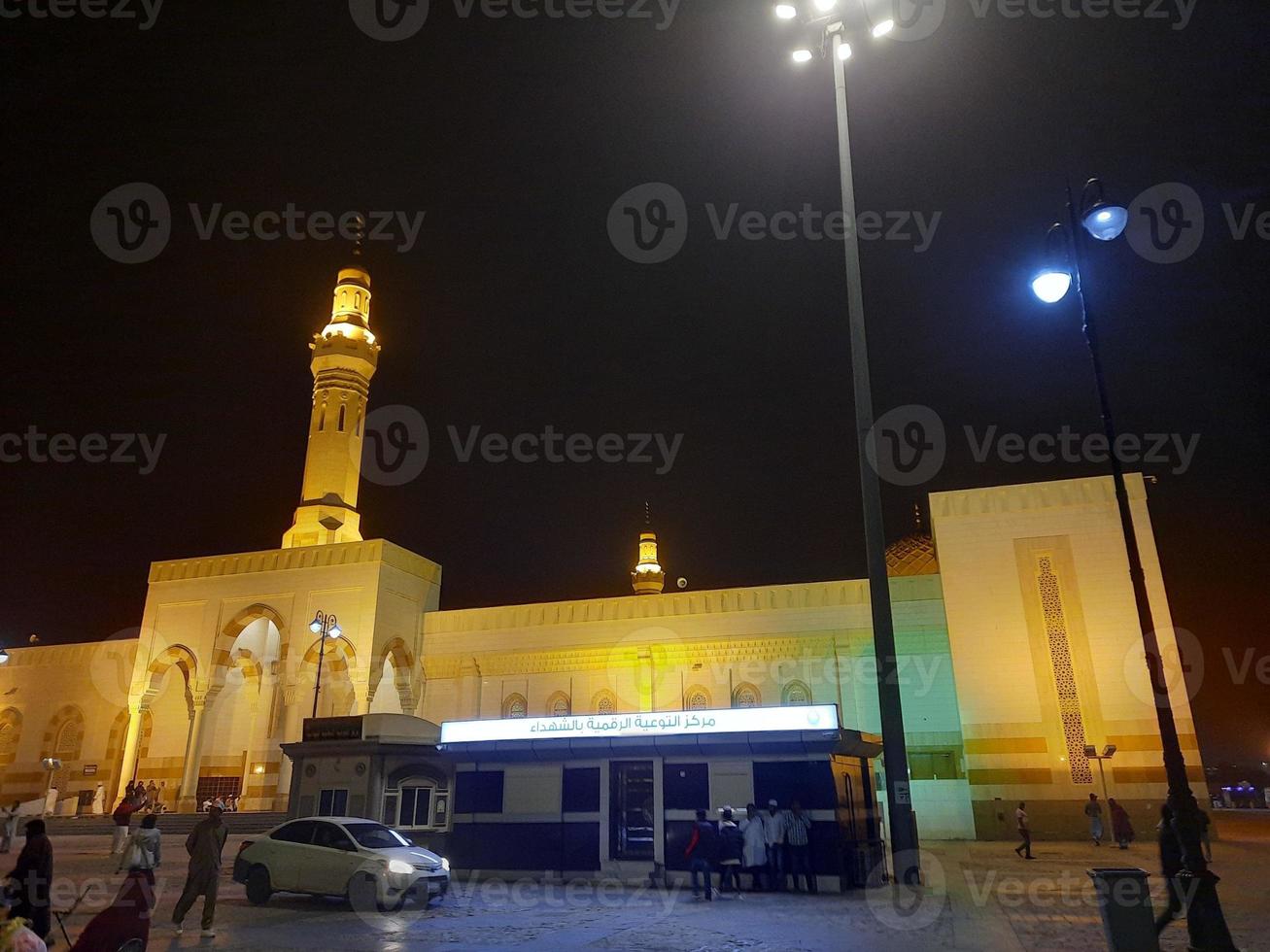 A beautiful night view of the Sayed Al Shuhada Mosque in Madinah, Saudi Arabia photo