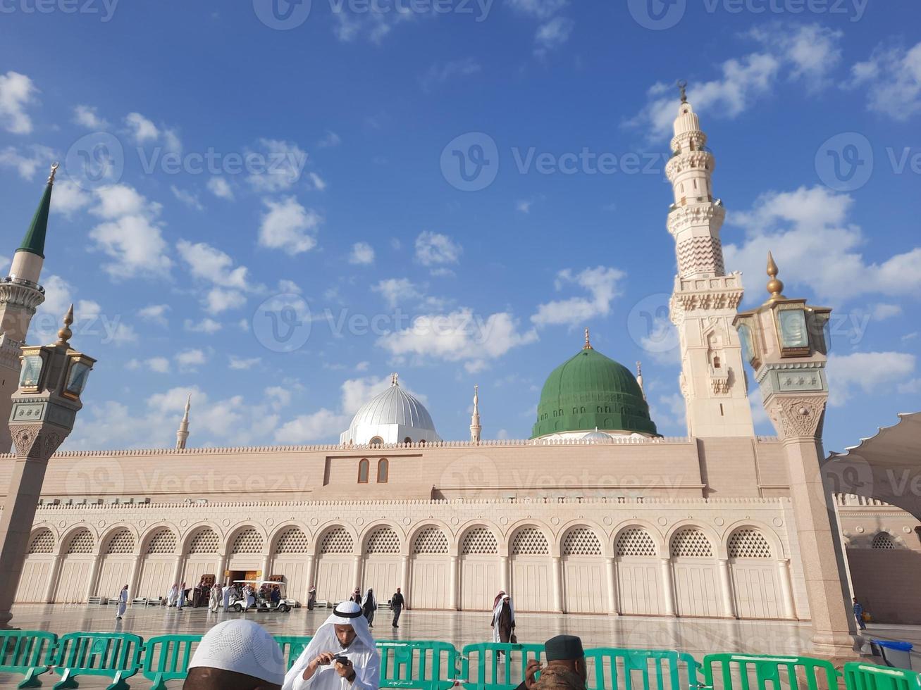 Beautiful daytime view of Masjid Al Nabawi, Medina's green dome, minarets and mosque courtyard. photo