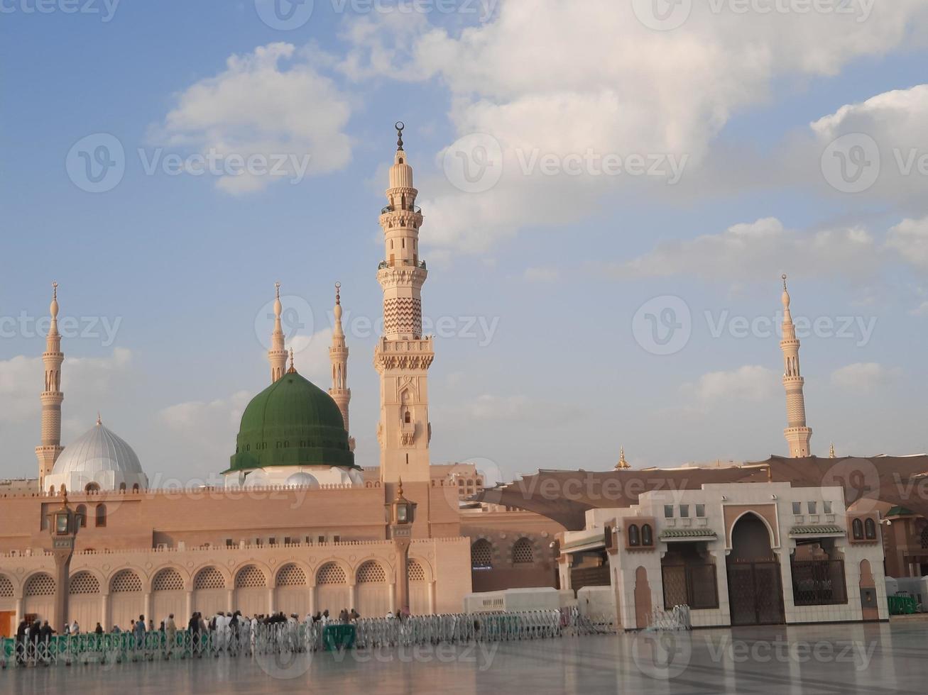 Beautiful daytime view of Masjid Al Nabawi, Medina's green dome, minarets and mosque courtyard. photo