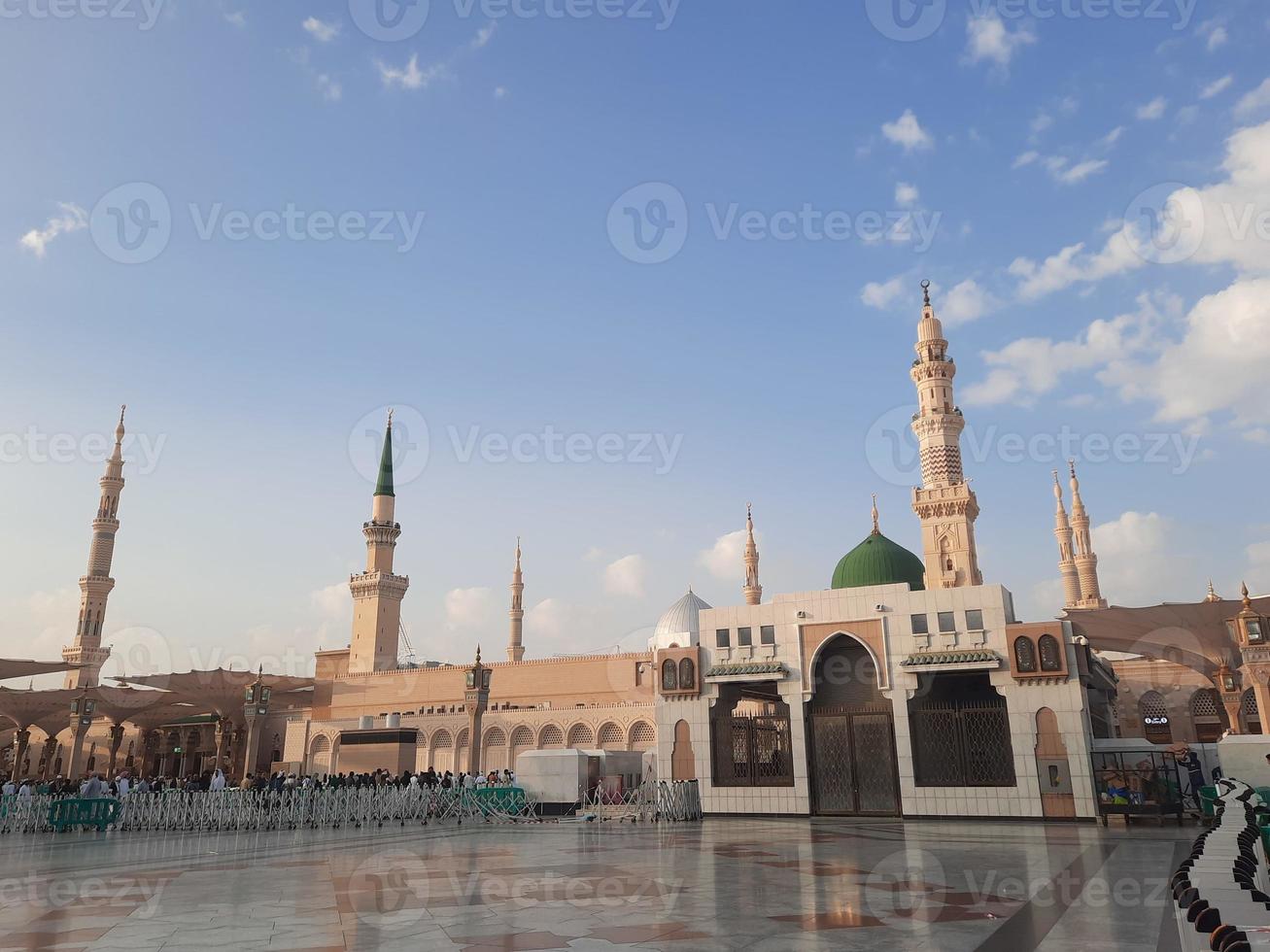 Beautiful daytime view of Masjid Al Nabawi, Medina's green dome, minarets and mosque courtyard. photo