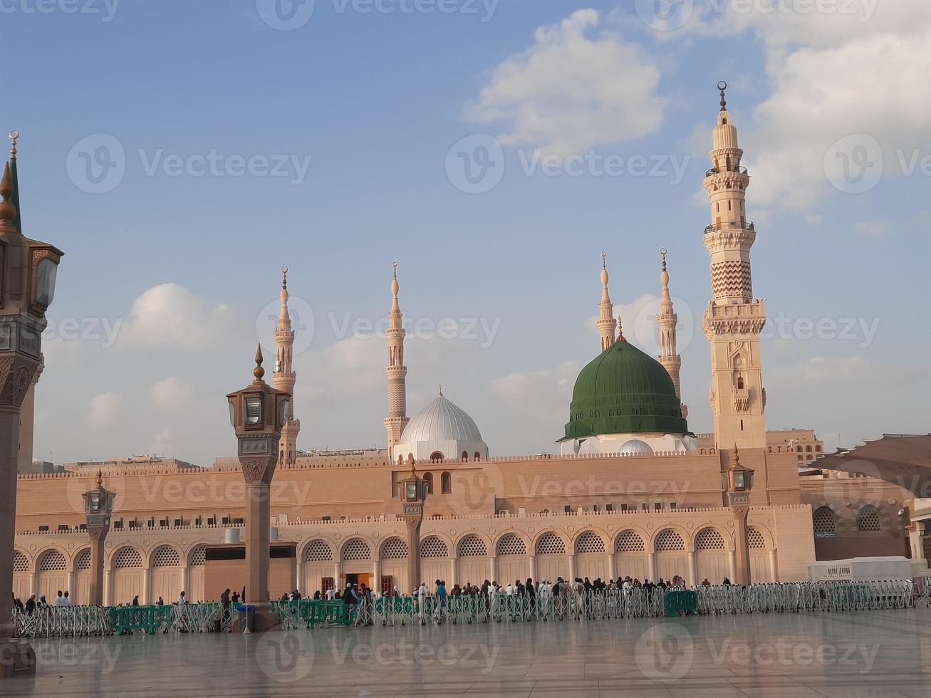 Beautiful daytime view of Masjid Al Nabawi, Medina's green dome, minarets and mosque courtyard. photo