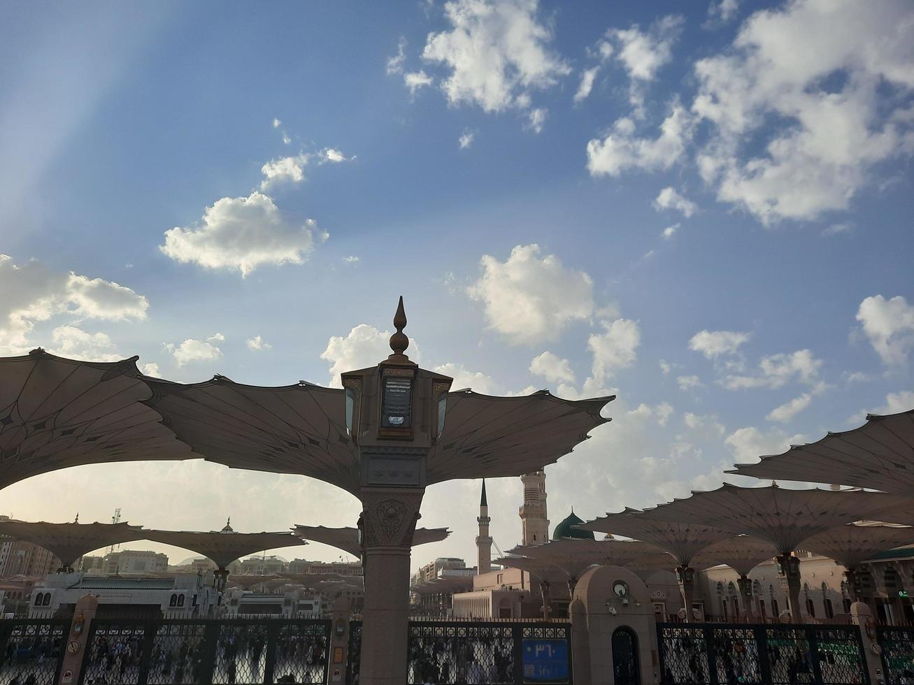 Medina, Saudi Arabia, Dec 2022 - During the day pilgrims from all over the world gather in the outer courtyard of Masjid Al Nabawi, Medina, Saudi Arabia. photo