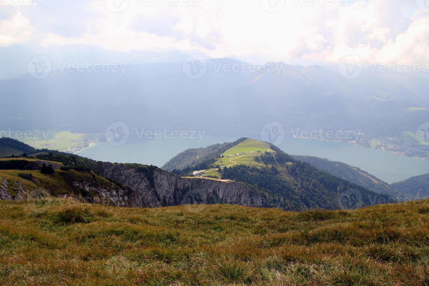 Travel to Sankt-Wolfgang, Austria. The view on the mountains and a lake in the clouds. photo