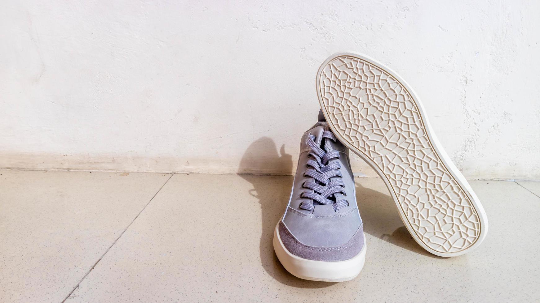 the gray sneakers on the floor photo