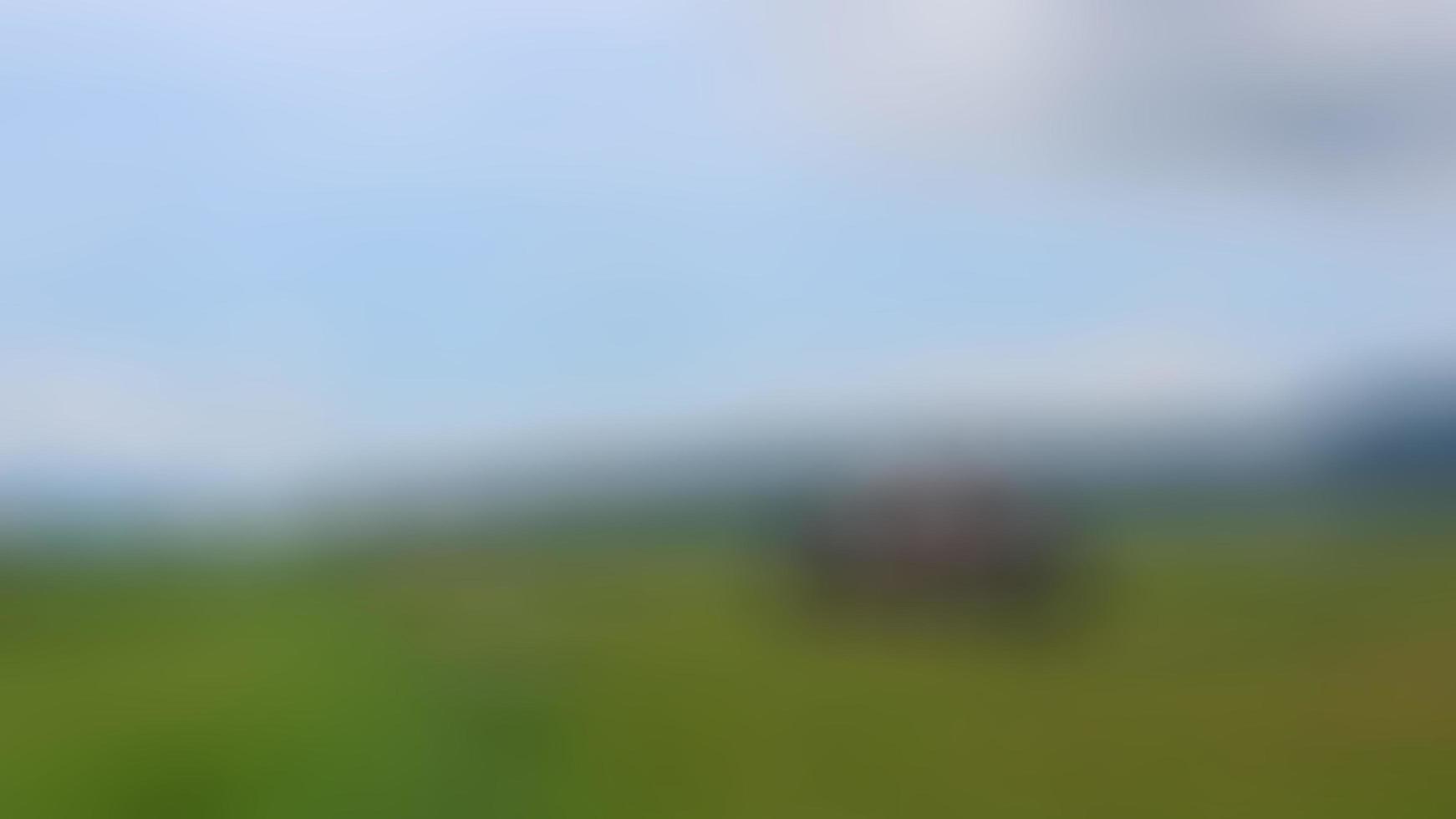 defocused cabin in the middle of the rice fields surrounded by hills photo