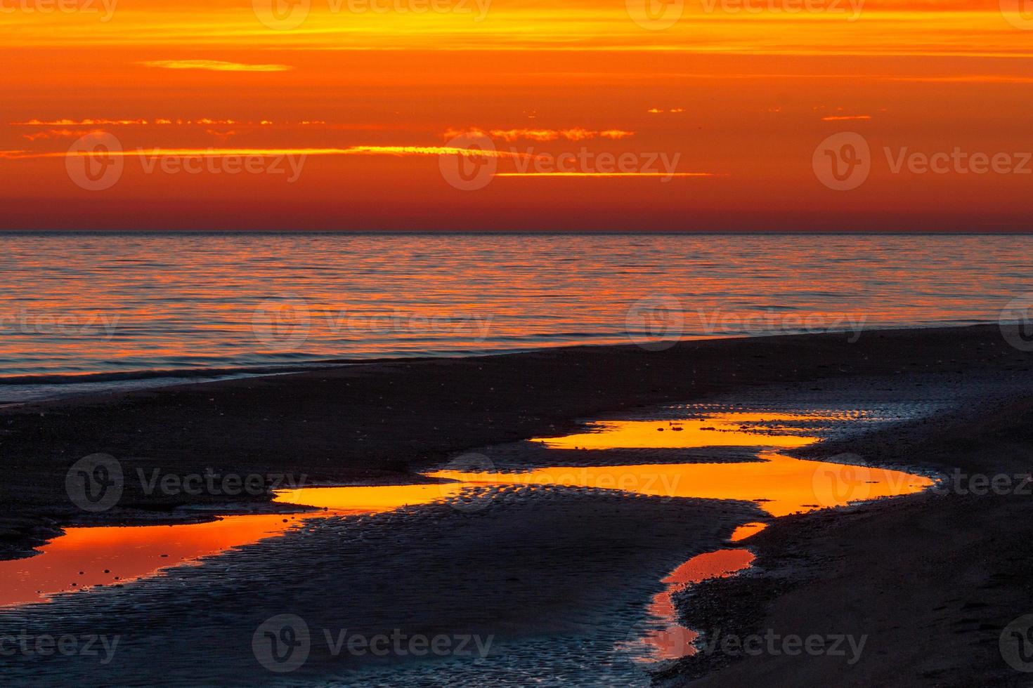 patrones en la arena del mar al atardecer foto