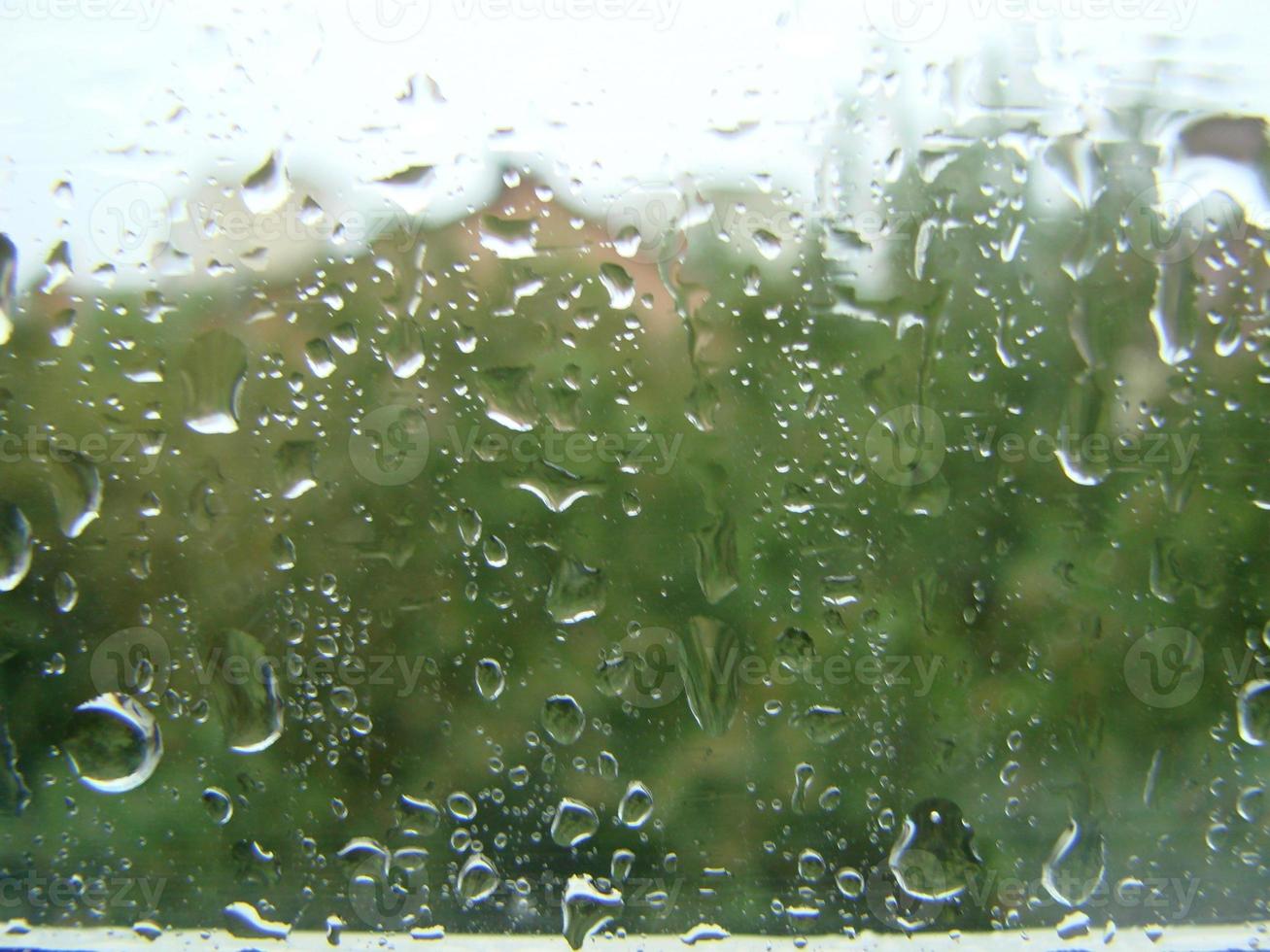 rainy days rain drops on the window surface photo