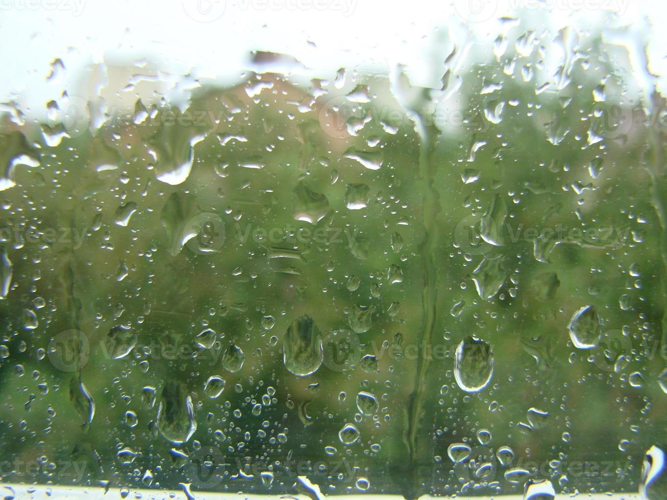 rainy days rain drops on the window surface photo