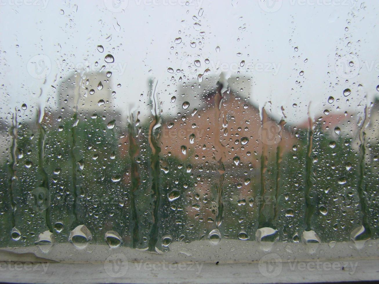 rainy days rain drops on the window surface photo