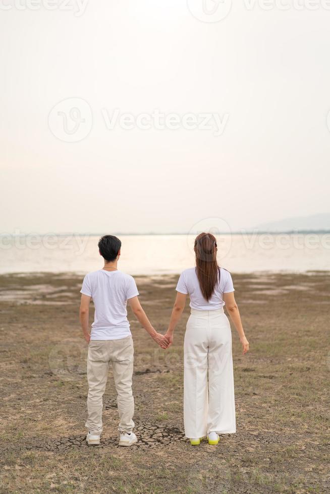 Happy young Asian couple in bride and groom t-shirt photo