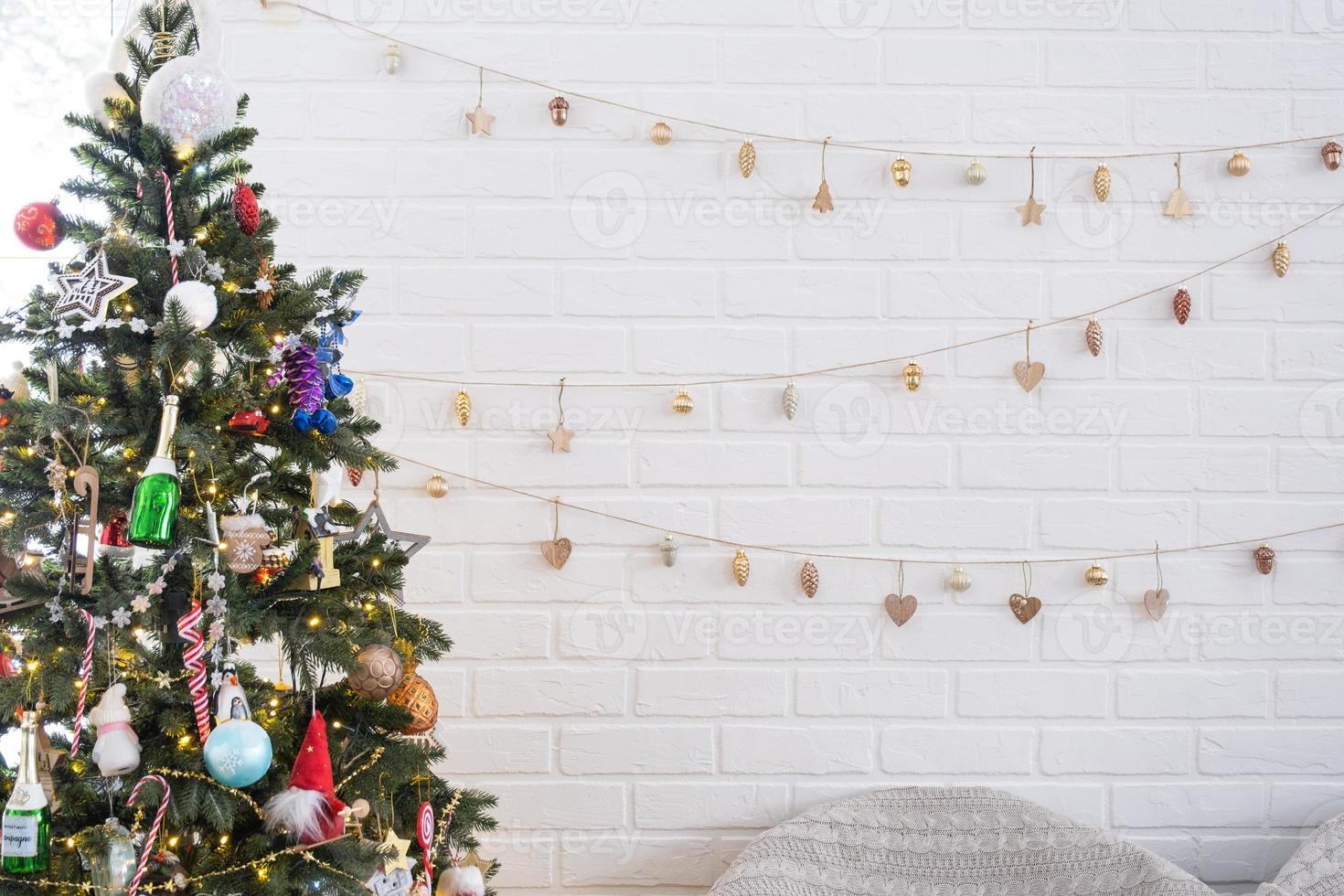 Christmas tree in white interior of a house with loft-style brick ...